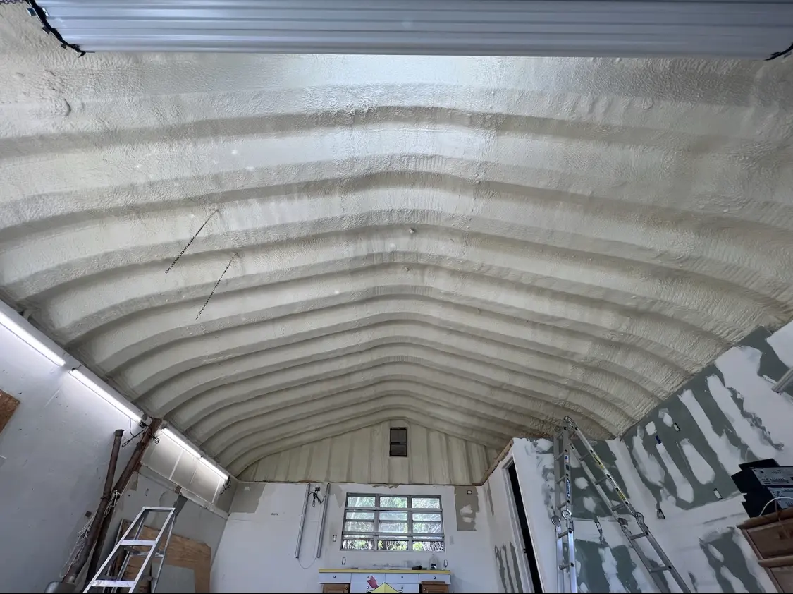 Spray polyurethane foam applied to the underside of a metal roof deck in Brookline